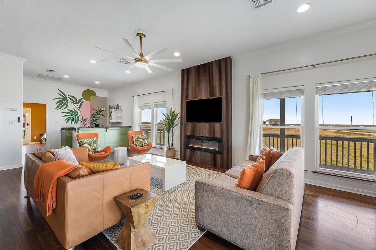 Modern Coastal design and decor features a wood slat fireplace on chilly mornings, centrally located living space with wet bar